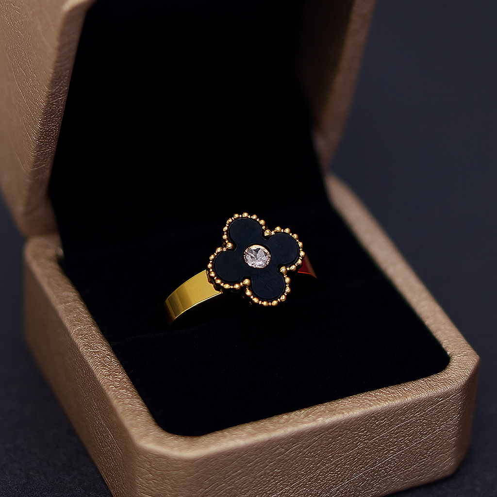 Flower-shaped ring with a diamond in a brown box on a dark background